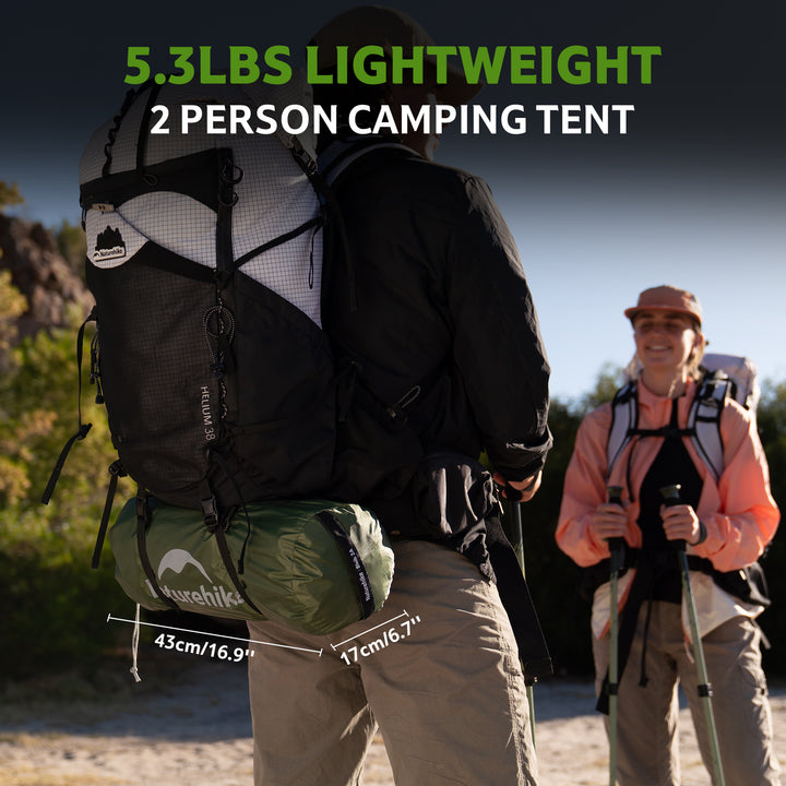 Two hikers carrying backpacks outdoors, each with a compact Bleik 2-Person Backpacking Tent strapped under their pack. Lightweight, ultralight green tent ideal for backpacking, hiking, trekking, and multi-day outdoor adventures. Portable, easy to carry, small packed size, durable 210T polyester, freestanding double wall tent for two-person camping, suitable for trail hiking, bikepacking, and adventure travel.