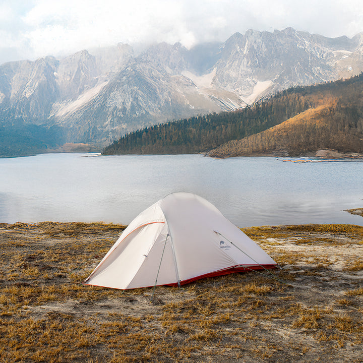 Naturehike Cloud Up Pro 3-Person ultralight backpacking tent set up by a mountain lake, grey and red color, waterproof and wind-resistant shelter for hiking and camping.