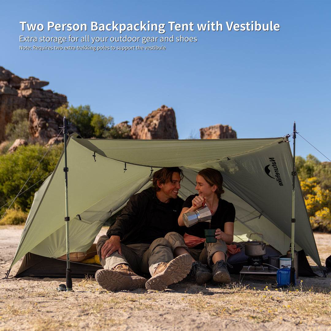 Naturehike Mongar Pro 2-Person ultralight backpacking tent in real outdoor setting with two people sitting inside, featuring spacious vestibule for extra gear and shoe storage, lightweight freestanding double wall hiking and trekking tent designed for two person camping adventures