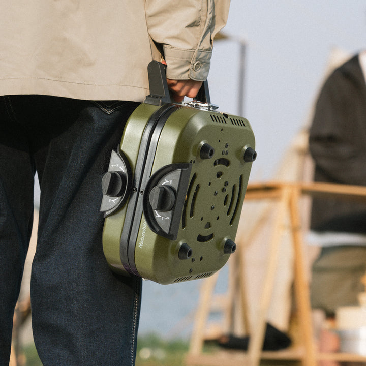 Person easily carrying the Naturehike Phantom 2-Burner Folding Camping Stove in its compact included carry bag, demonstrating its ultra-portable and lightweight design for easy transport to any outdoor adventure.